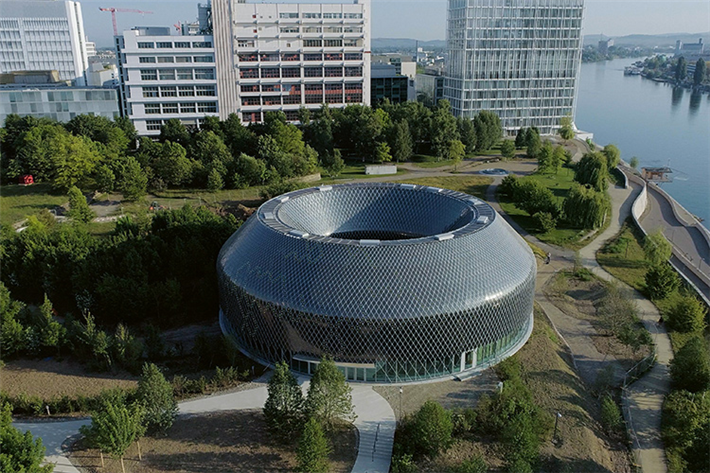 Die PV-Fassade des Novartis-Pavillons in Basel ist Wetterschutz und produziert Strom. Zusätzliche LED-Elemente verleihen dem Gebäude nachts eine atemberaubende Attraktivität. © iart
