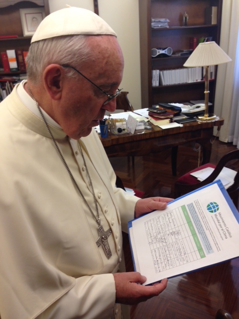 Pope Francis holds the Catholic Climate Petition in his personal office © GCCM